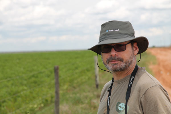 Herpetologist Reuber Brandão ponders a soy plantation on the edge of Grande Sertão Veredas National Park in the Brazilian Cerrado. Photo credit: Brendan Borrell