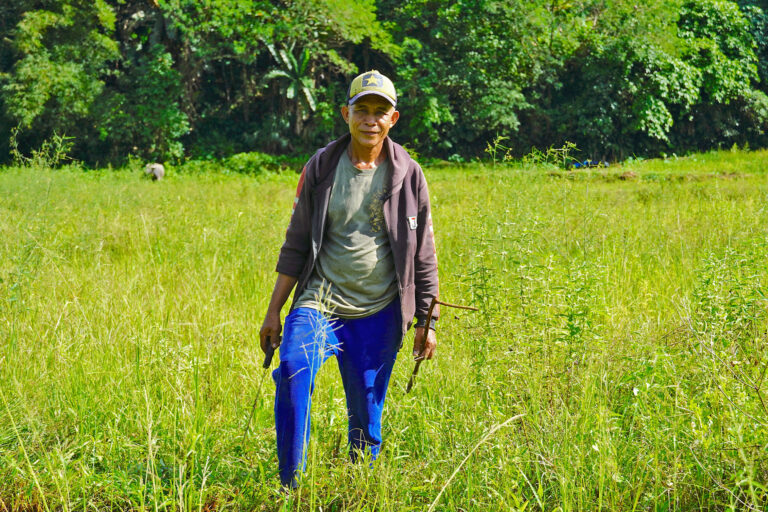 Indigenous farmer Leopoldo Lebuna weeds his lowland farm