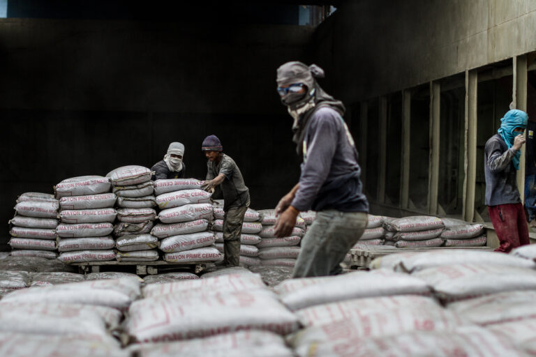 Workers loading cement.