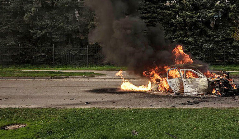 A car burns with two people inside, after a Russian bombardment in Kharkiv, Ukraine, Thursday, April 21, 2022. Image by AP Photo/Felipe Dana via Flickr.