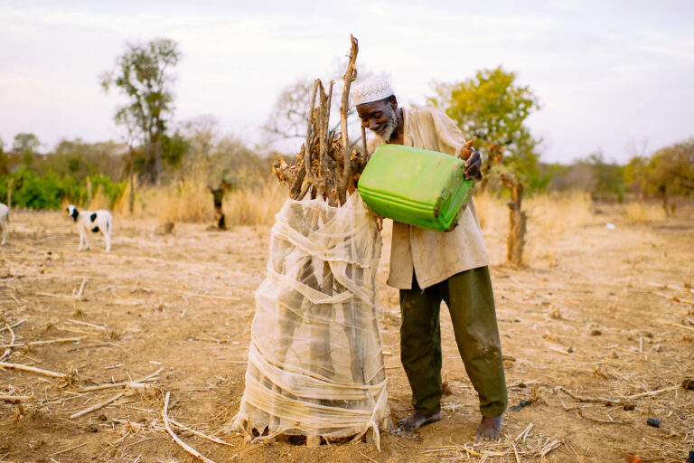 Kouanda Issiaka watering his mango plantation for extra income in Boromo, Burkina Faso.