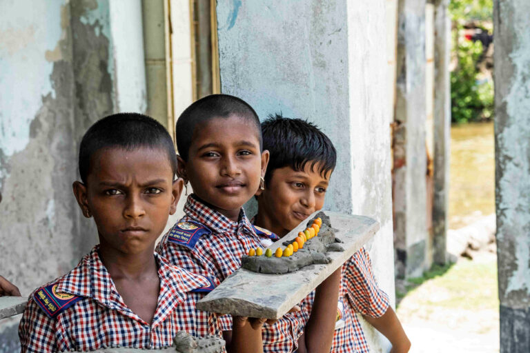 Students at the Gora Dhangmari Forest Primary School display clay sculptures they made for a final project in art class.