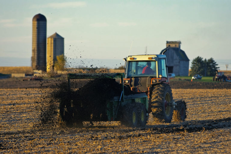 A farmer uses a manure spreader as a natural fertilizer. An excess of manure from livestock produces an excess of ammonia, a harmful nitrogen emission. Image by CityofGeneva via Flickr (CC BY-NC 2.0).