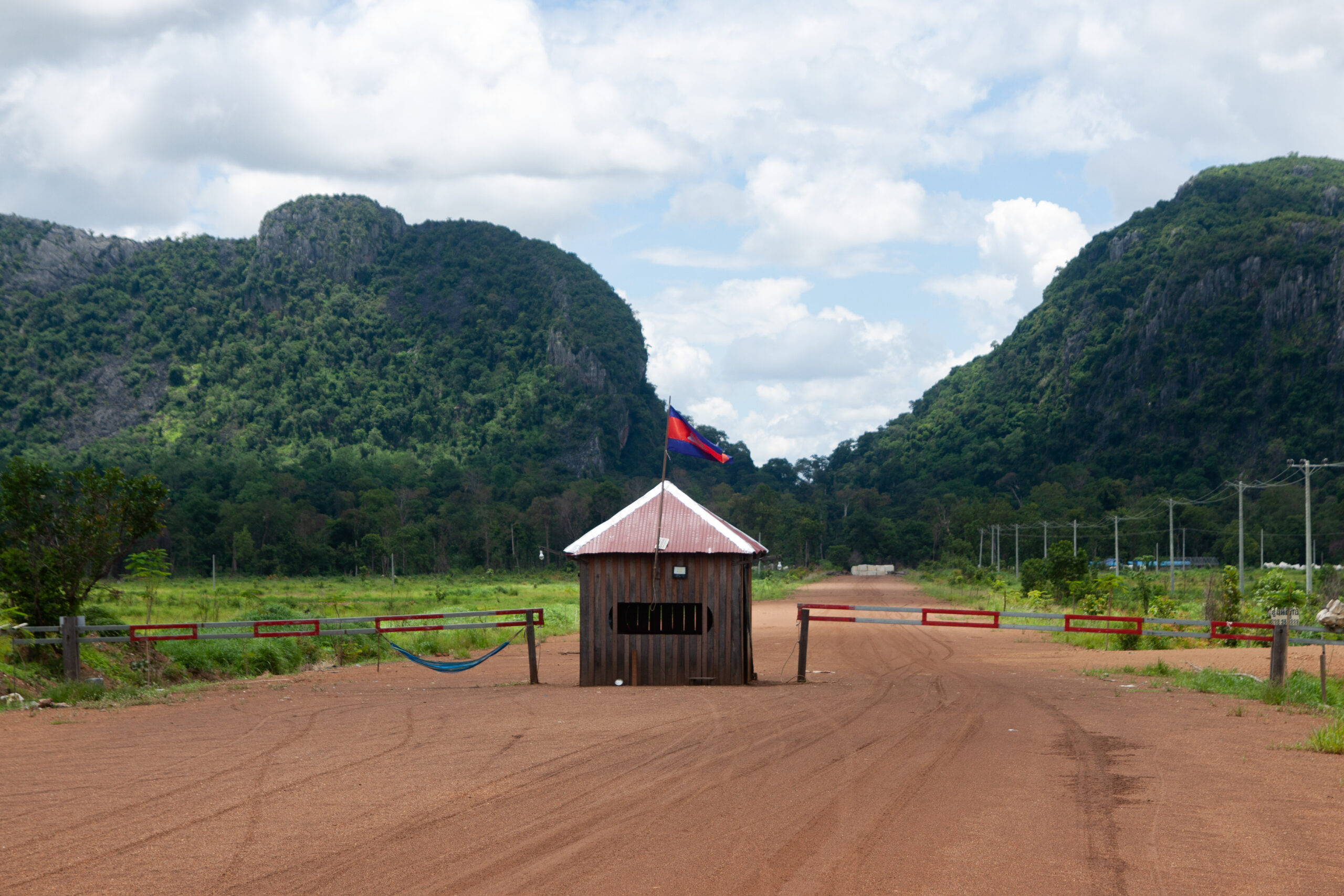 Lin Vatey's security staff refused to answer basic questions when Mongabay visited in August 2024, even refusing to say what the company does, despite blocks of marble visible from the checkpoint. Image by Gerald Flynn / Mongabay.