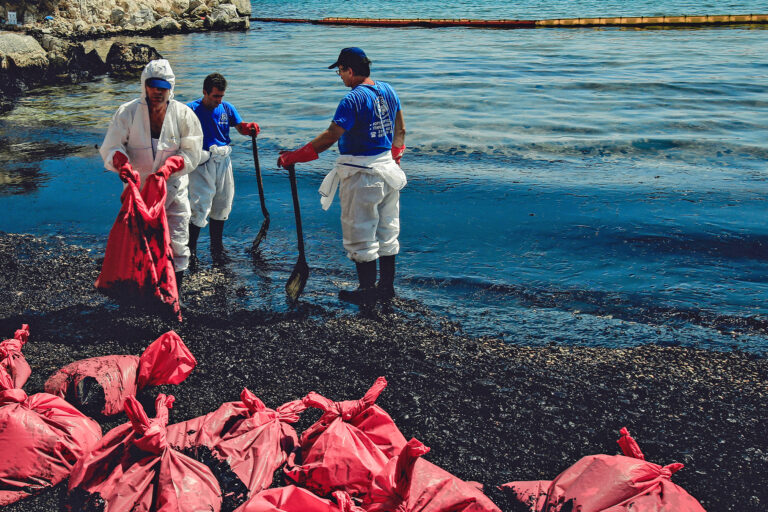 Workers clean an oil spill that has polluted a beach on Salamina Island, Greece.