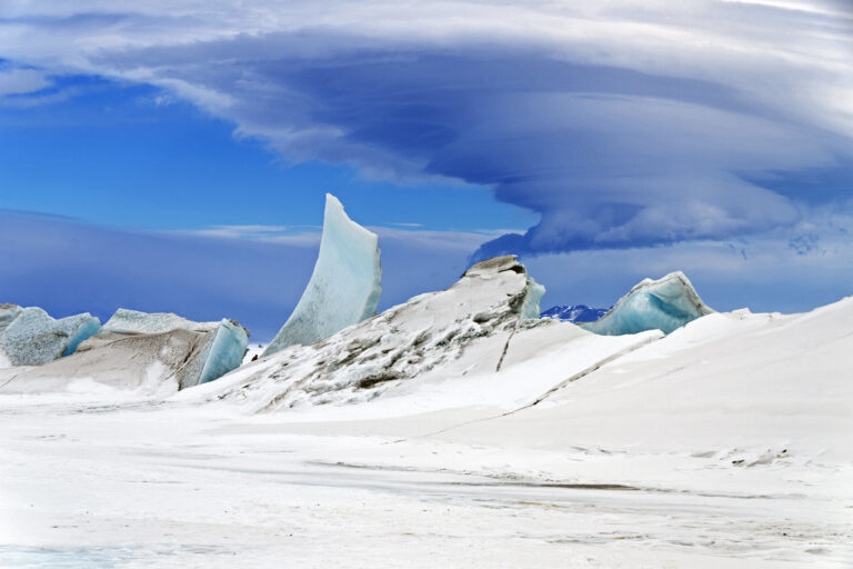 A multilayered lenticular cloud hovers near Mount Discovery, a volcano about 70 km (44 mi) southwest of McMurdo Station in Antarctica.