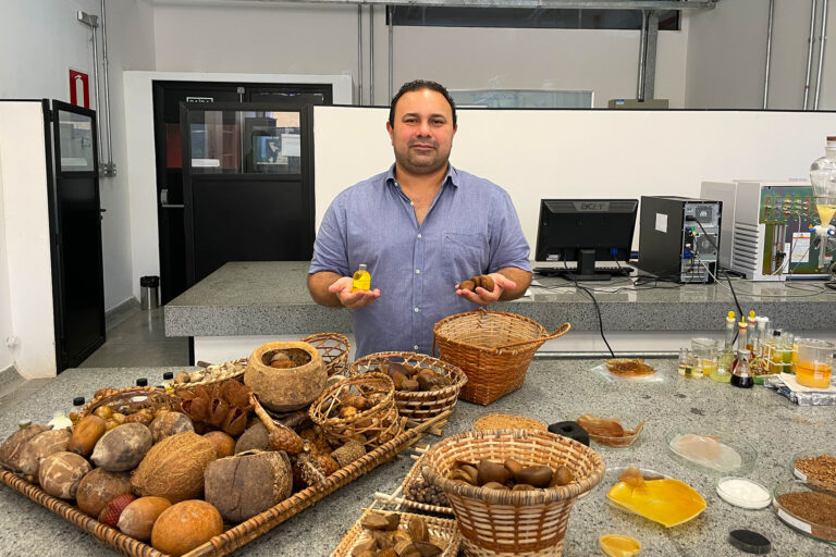 Luís Adriano Nascimento, chemist and vice-coordinator of the Laboratório de Óleos da Amazônia (Amazon Oils Laboratory, LOA), stands at a lab bench with a wide collection of Amazonian fruits and seeds used to make oils, biofuels and bioplastics.