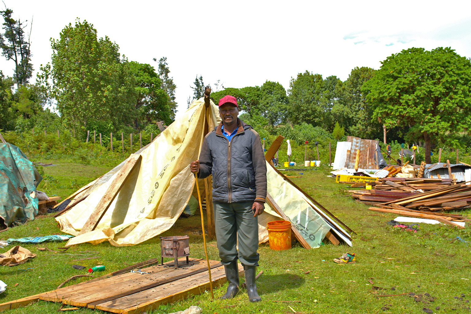 Samson Ragita outside his makeshift tent in his compound where his houses used to stand in Sasimwani.