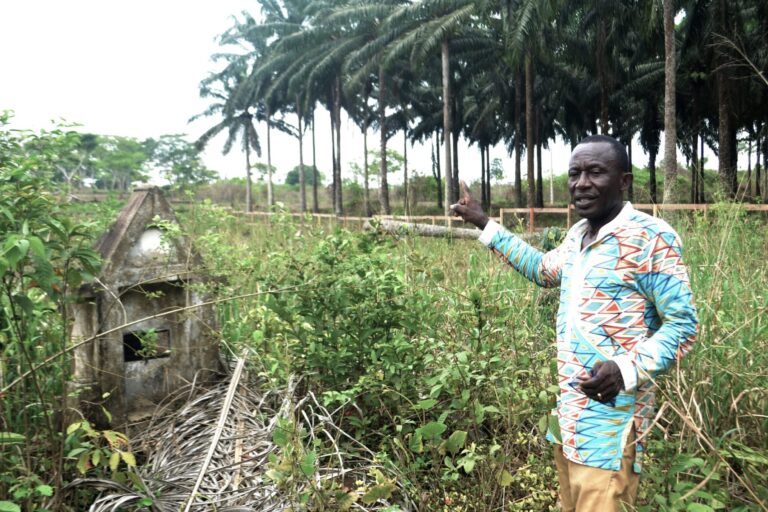 Activist Emmanuel Elong at the foot of an ancestral tomb on the sacred site of Bayong Mbonjo. Photo by Yannick Kenné.