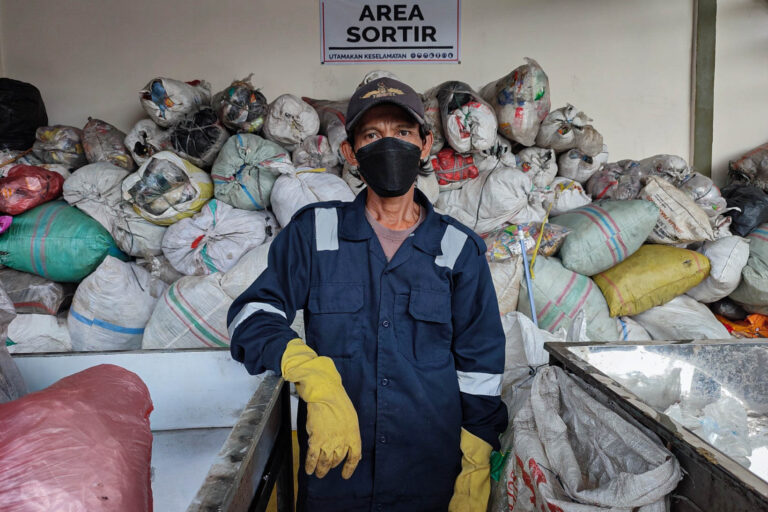 Officers sort waste at a waste processing site in Bogor City, West Java.