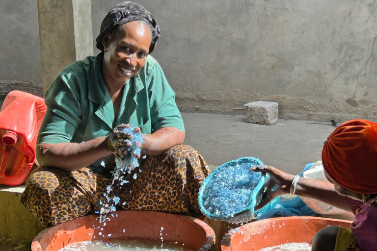 The Deekali Project: Women washing plastic waste to prepare for the grinding machine at a local recycling facility in Senegal.