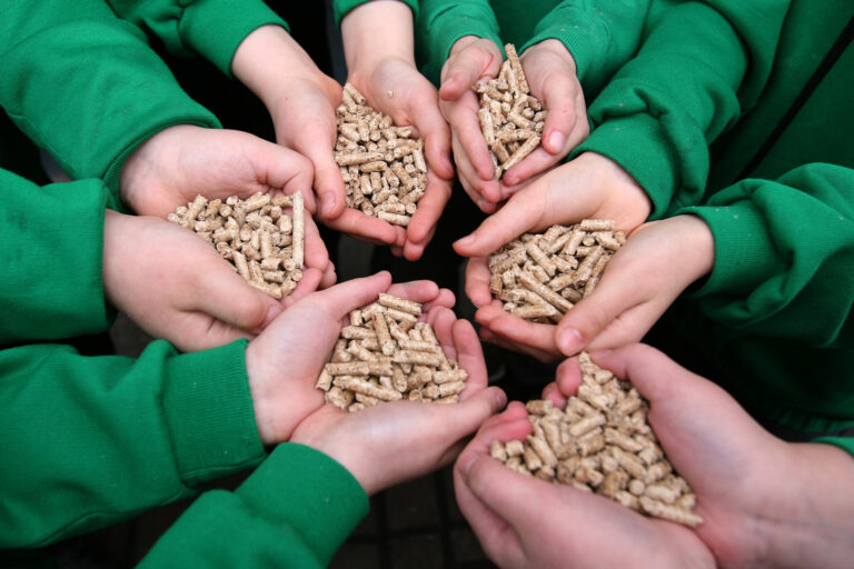 People holding wood pellets.